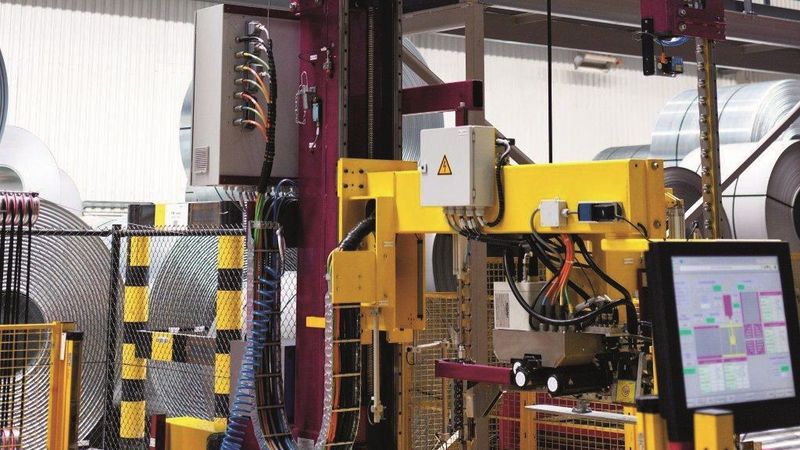 Das Grundgestell der Umreifungsanlage ist für unterschiedliche Ringdurchmesser verfahrbar. Die Leitungen laufen auch hier in Energieführungen aus Stahl von Tsubaki Kabelschlepp. (Bild:  Tsubaki Kabelschlepp)