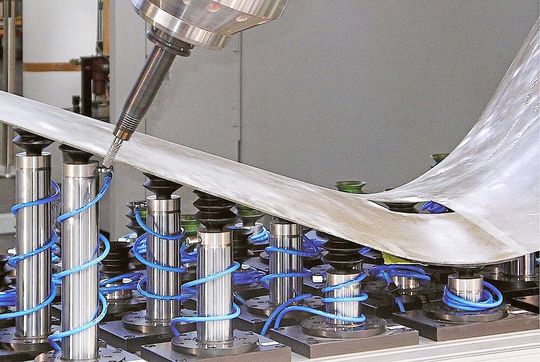 A thin-wall, free-form component clamped in a Roemheld FSS workholding system, ready for 4-axis machining.(Source:  Roemheld)