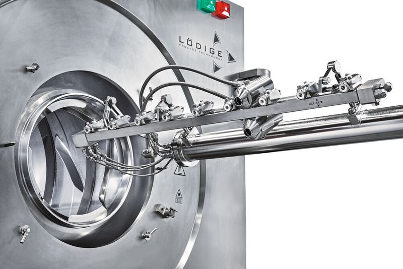 Coater with extended nozzle arm, view from below. (Source: Gebr. Lödige Maschinenbau)