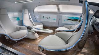 Mit dem Rücken in Fahrtrichtung sitzen kann Übelkeit verursachen. Auslöser ist ein Verarbeitungskonflikt im Hirn. (Daimler)