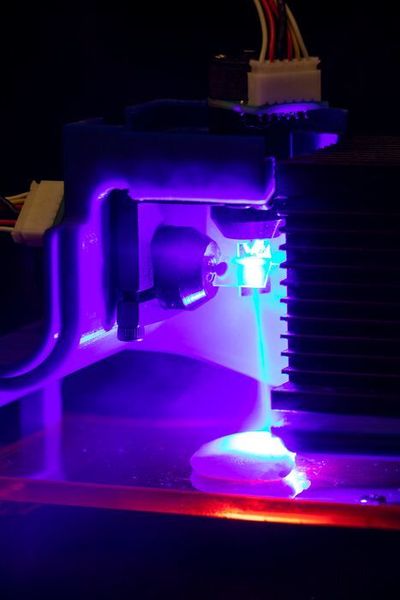 Chicken being cooked by a blue laser. Light is being directed by two software-controlled mirror galvanometers. (Columbia Engineering)