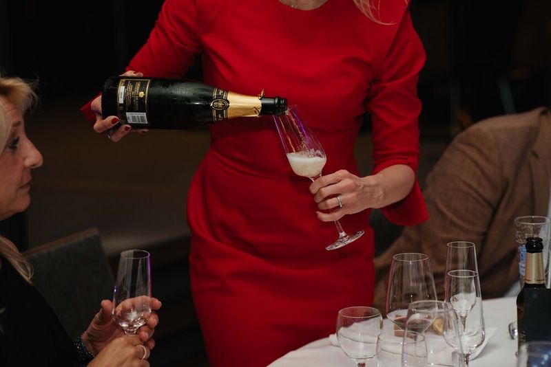 Eva Kanzler, eine der beiden Chefinnen der Vogel IT-Akademie, gießt schon zur Vorbereitung auf die ersten Gewinner den edlen Schaumwein ein.  (Bild: Manuel Emme Fotografie)