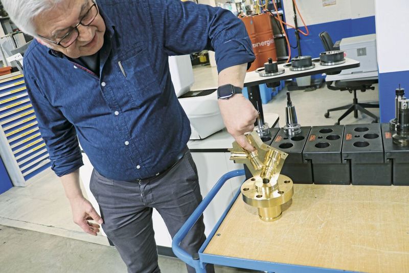 Henryk Fray, Fertigungsleiter Armaturentechnik, mit einem Bordventil. Die wirtschaftliche Bearbeitung des aus einer speziellen Bronze bestehenden Teils stellt grosse Anforderungen an das Zerspanungs-­Know-how und Fertigungs­equipment.  (Bild: Haimer)