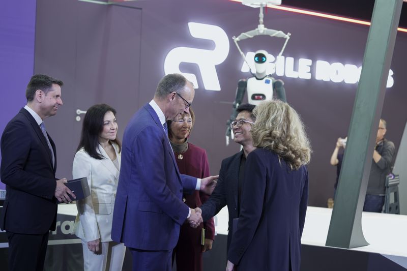 Bei Agile Robots informierten sich Friedrich Merz und Wirtschaftsministerin Katherina Reiche über die strategische wirtschaftliche Bedeutung von Physical AI für die industrielle Wettbewerbsfähigkeit. Sie erhielten eine Live-Demonstration der Lösungen des Unternehmens und  einen personalisierten Miniatur-Roboterarm. (Bild: Agile Robots)