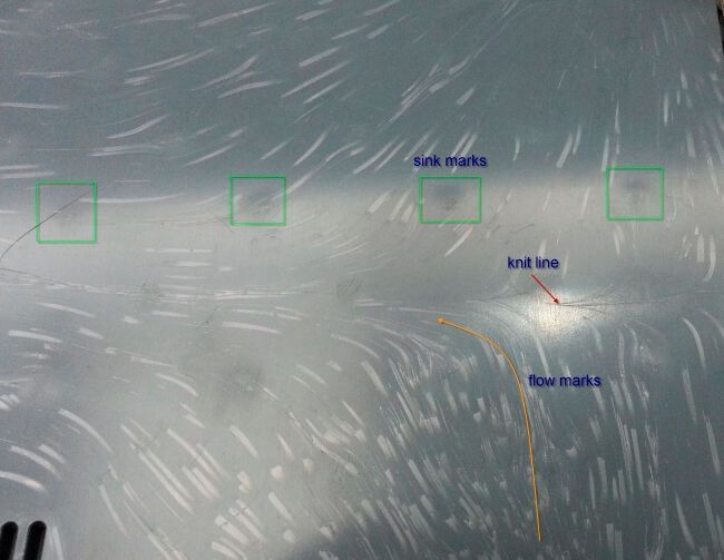 Flow lines or marks appear as banded discolouration on the surface.