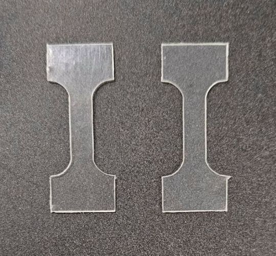 PLA plastic (left piece) usually takes months to break down in industrial composting facilities, but incorporating a sprinkling of an organic additive dramatically speeds the process for a modified PLA plastic (right piece) to less than three weeks. (Source:  Jinsol Yook)