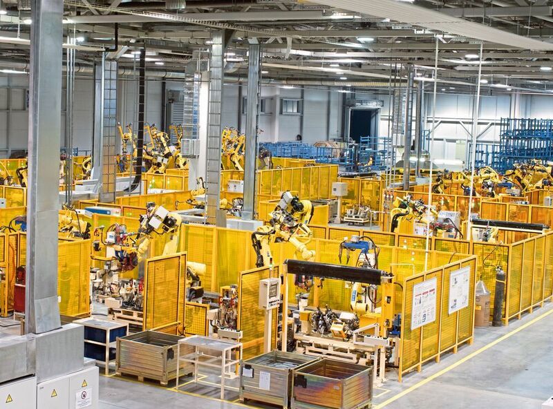 Figure 1: A production line with robotic arms on a factory floor. (©Vladimir Vydrin - stock.adobe.com)