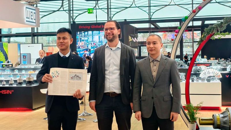 Chefredakteur von MM MaschinenMarkt Benedikt Hofmann besucht den Messestand von Wanshsin Seikou auf der SPS 2026 (v.l. Harry He - Director Overseas Department, Benedikt Hofmann - Chefredakteur MM MaschinenMarkt, Qingquan Zhou - CEO) (Bild: Bejagaur)