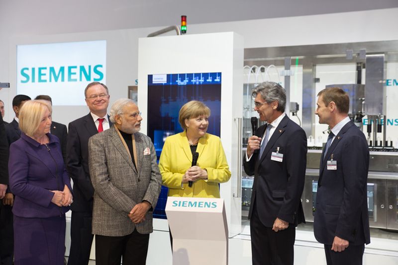 Modi and Merkel are seen along with Mr. Joe Kaeser, President and CEO, Siemens AG (second from right) and Klaus Helmrich, Member of the Managing Board of Siemens AG. (Siemens AG)