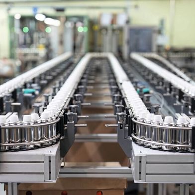 An advantage of Minitec's link chain conveyors: They allow very small curve radii, enabling a high buffer volume of the spray cans. (Image:Minitec)