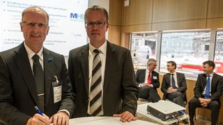 Dr. Michael Wenzel (links) und Prof. Bernd Kuhlenkötter bei der Unterzeichnung des Memorandum of Understanding auf der Automatica 2012. (Bild: Messe München)