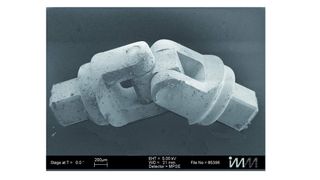 Vorserientyp eines Mikro-Kardangelenks mit einer Länge von 270 µm und Bohrungsdurchmesser von 0,1 mm zur Aufnahme der Stifte; die Teile werden auf einer Mitsubishi-Drahterodiermaschine gefertigt, die Bohrungen senkerodiert.Bild: Mitsubishi Electric (Archiv: Vogel Business Media)