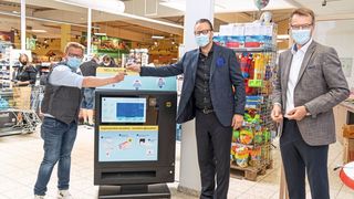 Premiere für den Verkaufsautomaten Prevent: E-Center Marktleiter Stefan Hartmann (l.) freut sich über die offizielle Geräte-Übergabe durch Harting-Vorstandsvorsitzenden Philip Harting (m.) und Peter Weichert, Geschäftsführer der Tochtergesellschaft Harting Systems.    (Harting)