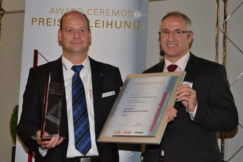 Stephan Brand, International Marketing Manager at Aerzener Maschinenfabrik (left) is happy about the Innovation Award in the category Plant Engineering and Processing Components. At the Powtech 2011, the firm presents the Delta Hybrid for the first time in a vacuum version.  (Picture: PROCESS)