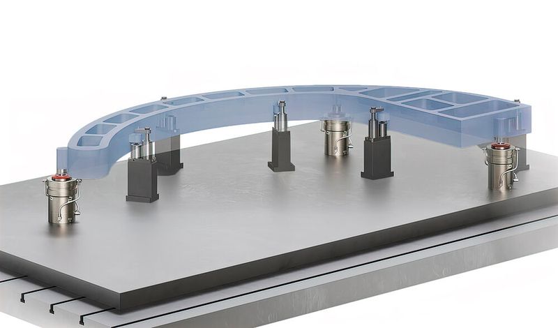 A hybrid Stark.spheric set-up where the pedestals are used purely to position an aerospace component. In this case, downward holding pressure is applied by swing clamps acting on sacrificial lugs. (Source: Roemheld)