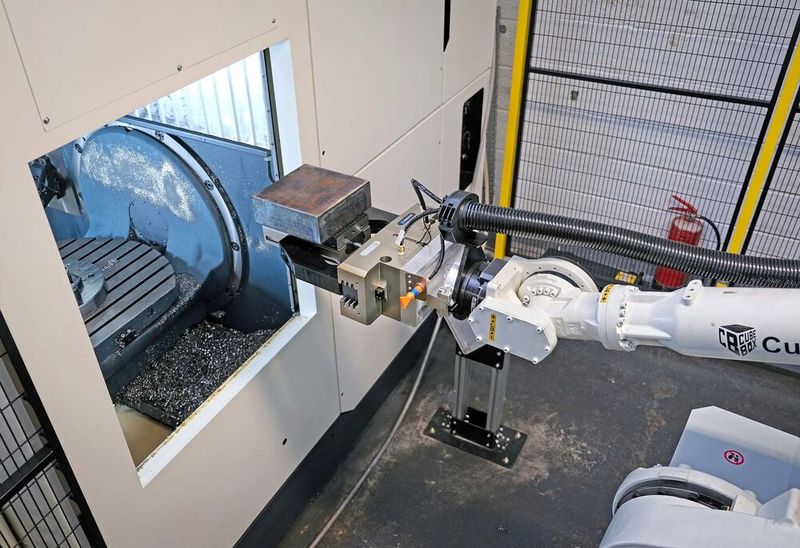 The robot about to place the billet into the machine. (Source: Whitehouse Machine Tools )