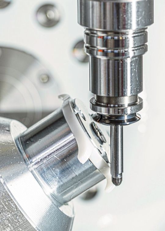 Hier wird ein Uhrengehäuse aus Zirkonoxid auf einer Kern Micro HD 5achsig mit Voll-PKD-Werkzeugen gefräst. Hier wird ein Uhrengehäuse aus Zirkonoxid auf einer Kern Micro HD 5achsig mit Voll-PKD-Werkzeugen gefräst.