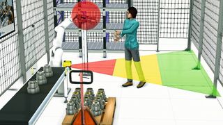 Dreidimensionales Mock-up einer MRK-Anwendung: Gefahr für die Werkerin geht vom Werkzeug am Roboterarm aus (roter Kreis). Als Sicherheitsmaßnahme ist ein Laserscanner, am Fließband befestigt, vorgesehen, der die Werkerin erkennt. Im grünen Bereich droht ihr keine Gefahr, im gelben bewegt sich der Roboter langsamer und im roten wird er angehalten.  (Fraunhofer-IPA)