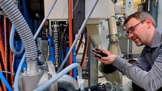 Der Reaktruder vermahlt die Elastomer-Reste. Dr. Stefan Hoyer, wissenschaftlicher Mitarbeiter am Institut für Strukturleichtbau der TU Chemnitz, begutachtet das Feinmehl. (Hendrik Schmidt)