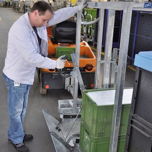 Bild 1: Die auf Trolleys bereitgestellten Behälterstapel lassen sich von beiden Seiten aus dem Cargo-Liner-Anhänger be- und entladen. 