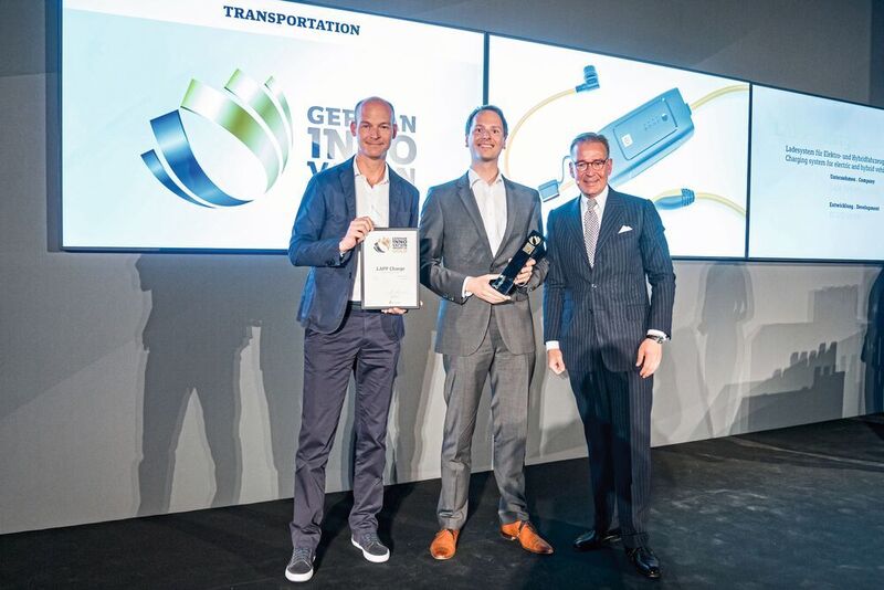 Sven von Boetticher, Inhaber von ID AID, und Lapp-CEO Matthias Lapp nehmen den German Innovation Award der Kategorie Transportation von Andrej Kupetz, Hauptgeschäftsführer des Rat für Formgebung, entgegen (v.l.n.r.).  (Lapp)