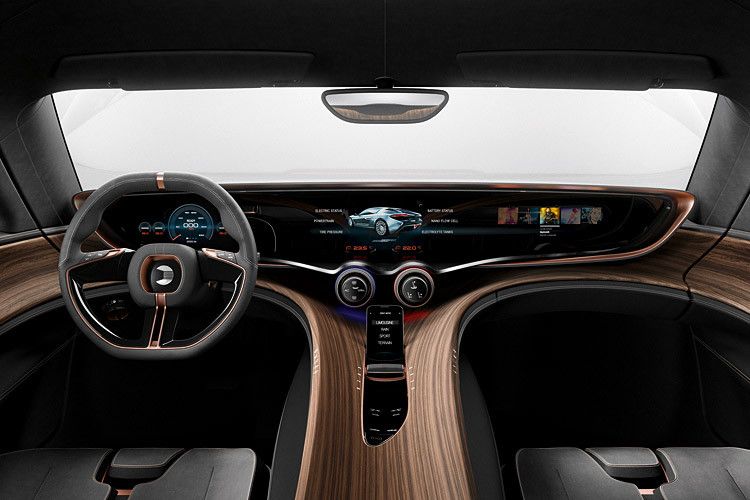 Im Innenraum dominieren edle Hölzer und geschwungene Formen den Quant E. Die beiden Sitzreihen sind im Jet-Cockpit-Stil gehalten. (Foto: Nanoflowcell)