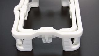 Die Universalhalterung für Radarsensoren wird per SLS-Verfahren mit PA12 gedruckt. Adam hat sie passend für die Produkte aus dem eigenen Haus auch selbst konstruiert. Der innere Rahmen ist beweglich. (© Simone Käfer)