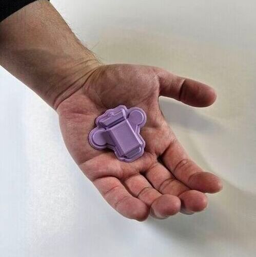 Wearable polygraph device in the palm of a hand for scale.(Source:  John A. Rogers/Northwestern University)
