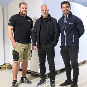 v.l.n.r: Salomon Zehnder, Leiter Produktion und Logistik bei Müller Holzbau AG, Michel Alder, CEO der isofloc AG und Tobias Frech, Verkaufsingenieur CH-Ost bei Sigmatek. Im Hintergrund die isofloc Industrie-Grossballen.(Bild:  Lion Communication)