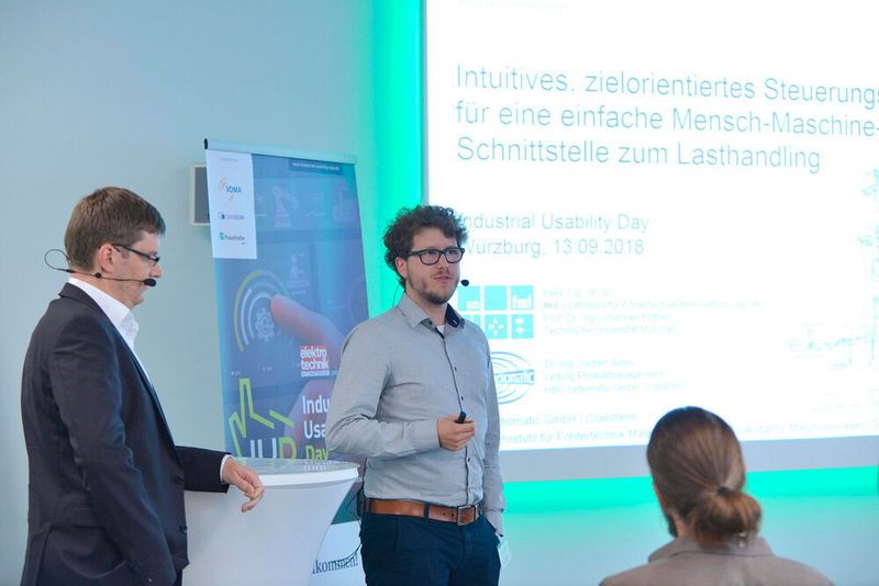Dr .Jochen Antes (links) der HBC-Radiomatic GmbH und Felix Top der TU München stellten ein Intuitives, zielorientiertes Steuerungskonzept für eine einfache Mensch-Maschine-Schnittstelle vor.  (J. Untch / Vogel Communications Group GmbH & Co. KG)