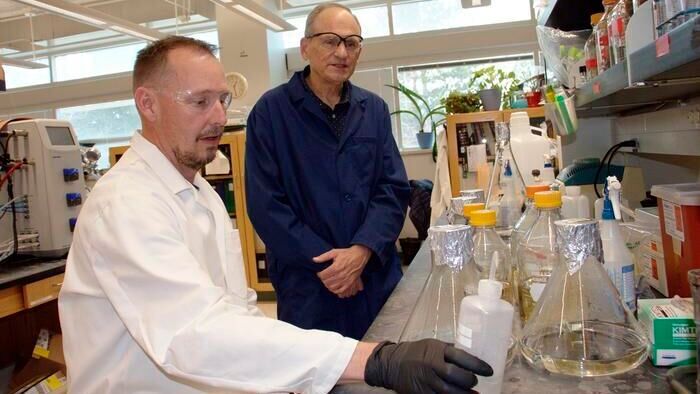 Utah State University biochemists Derek Harris, left, and Lance Seefeldt, and and fellow colleagues with the Nasa-funded Metal Utilization and Selection across Eons (Muse) project at the University of Wisconsin-Madison, are authors of a Jan. 22 ‘Nature Communications’ paper describing breakthrough research on ancient enzymes responsible for life on Earth.(Source:  M. Muffoletto, USU)