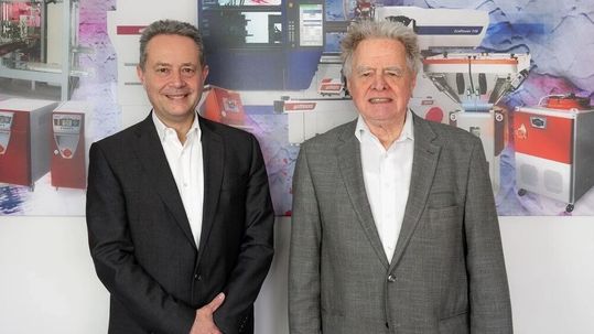 Michael Wittmann and Dr. Werner Wittmann (right) will jointly lead Wittmann Group’s consolidated Injection Molding Machines, Automation and Auxiliary Equipment divisions from May 1, 2026(Source:  Wittmann)