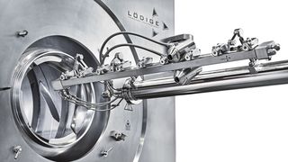 Coater with extended nozzle arm, view from below. (Source: Gebr. Lödige Maschinenbau)