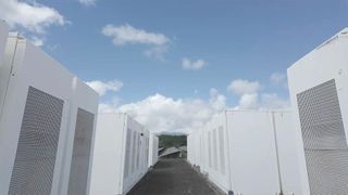 Rows of batteries on Kauai island provide more than just power: They stabilize the grid. A project between the Kauai Island Utility Cooperative, NLR, and several more partners showed that electronics can offer equal grid strength to spinning resources.  (Source: Connor O’Neil, National Laboratory of the Rockies)