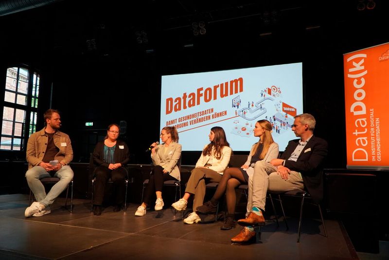 Paneldiskussion: „Gesundheitsdaten in die Anwendung bringen – wie geht’s wirklich?”. Moderator Dr. Tobias Krick (links) diskutiert mit den Panelisten, wie Gesundheitsdaten datenschutzkonform angewandt und genutzt werden können. (Bild: © IDG Institut für digitale Gesundheitsdaten RLP)