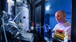 ORNL’s David Cullen stands in front of the new Thermo Scientific Spectra Ultra transmission electron microscope.  (Source: ORNL/ Carlos Jones, U.S. Dept. of Energy)