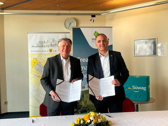 Dirk Gerber, Geschäftsführer der Süwag Grüne Energien und Wasser (links) und Alexander Immisch, Bürgermeister der Stadt Schwalbach (rechts) zeigen den unterschriebenen Vertrag: Die Wärme kommt aus dem "FRA03"-Rechenzentrum von Maincubes.(Bild:  Paula Breukel)