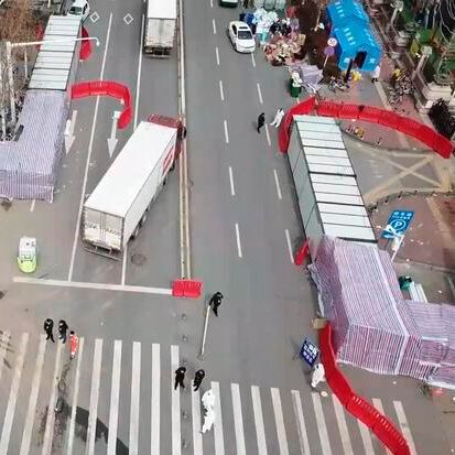 Professional sterilization teams can be seen outside the main entrance of the Huanan Seafood Wholesale Market in Wuhan, China in March 2020, shortly after its closure. (Source:  China News Service/ Wikipedia)