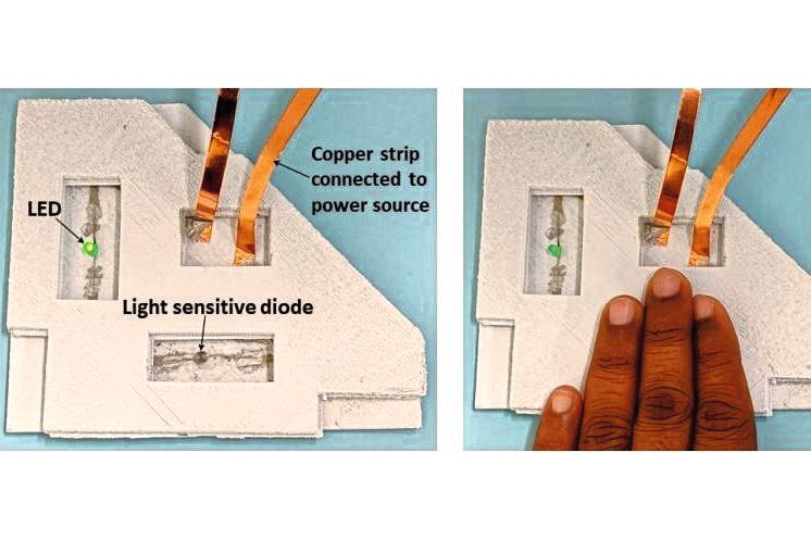 Proof-of-Concept: Das Beispiel zeigt eine einfache lichtempfindliche Elektronik mit einer LED, einer lichtempfindlichen Diode und einer Stromversorgung, die durch eine Hochleistungsschaltung im Inneren des Polymers verbunden ist. 