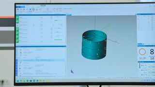 The dimension inspection process for the workpiece reference. The measurement software interface is displayed on the system monitor, which includes a 3D model of the measured surface of the part and the parameters of the inspection program. (Source: Mitutoyo Europe)