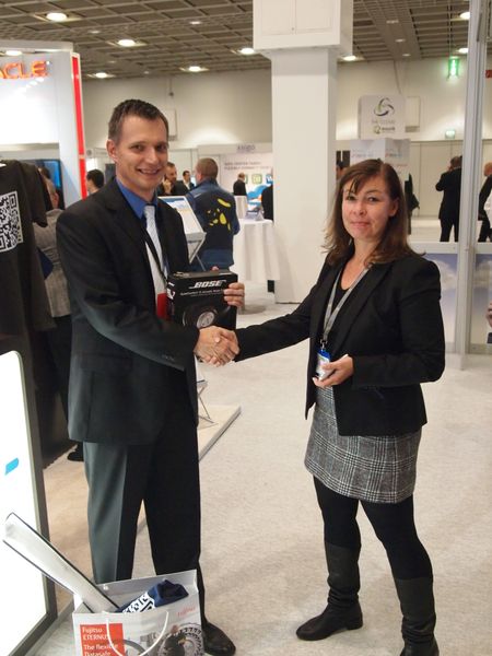 Christine Bachmeyer von Quantum gratuliert dem Gewinner eines Außenlärm-reduzierenden Bose Quiet Comfort 15 Kopfhörer. (Rainer Graefen)