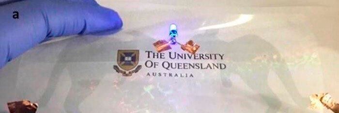 Nanomesh on PET substrate as a kangaroo-patterned transparent and flexible circuit lighting up a blue LED. 