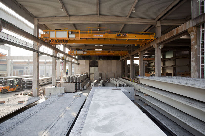 Bei Dreßler Bau transportieren zwei Zweiträger-Brückenkrane von Konecranes Betonfertigteile aus der Produktionshalle durch den Vorhang in das Freiluft-Zwischenlager. (Bild: Konecranes)