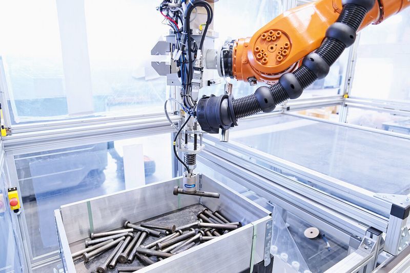 Nachdem das Greifsystem mit dem gegriffenen Boden und Deckel um 180° geschwenkt ist, pickt der Schunk Magnetgreifer EGM einen Pin aus der Kiste. (Schunk)