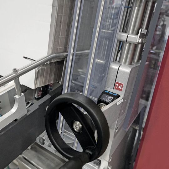 Überwachte Formateinstellung an einer Somic 424 TD (Tray-Deckel-Maschine mit außenliegendem Deckel) durch die Positionsanzeige Siko AP05. Sobald der Istwert im oberen Anzeigenfeld durch Drehen der Kurbel mit dem unteren Sollwert übereinstimmt, schaltet die Status-LED von Rot auf Grün um: Position korrekt.(Bild:  SOMIC)