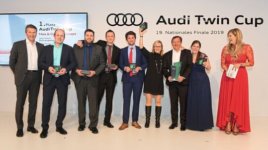 Serviceleiter Raimund Thomandl (links) und Moderatorin Verena Wriedt (rechts) gratulieren dem Sieger-Team vom Autohaus Mais-Glandien. Zum Vergrößern bitte klicken.(Bild:  Audi)