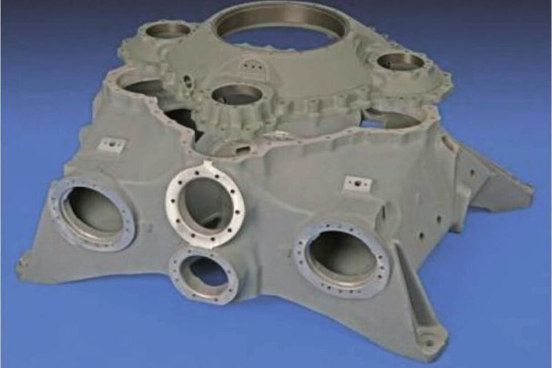 Sand-cast helicopter transmission made of ZE41 and cover made of WE43; dimensions 1.4 m x 0.85 m x 0.45 m with a weight of about 100 kg of the transmission and 27 kg of the cover.
