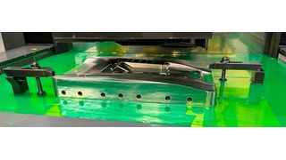 A component in the process of being spark machined on the Mitsubishi machine from ETG at Denmark. (Source: Denmark )