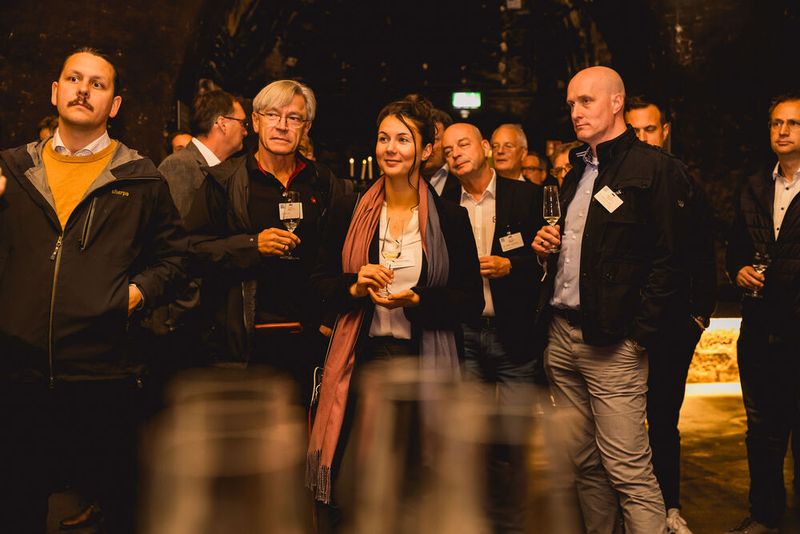 Die Besucher lauschen gespannt der fachkundigen Weinmoderation, die nähere Informationen zu den Charakteristika der Weine, deren Gärzeiten und Anbauregionen rund um Würzburg gibt. (Bild: Stefan Bausewein)