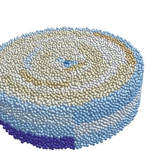 Abbildung 1: STAR-CCM+-Simulation mit DEM, die ein pharmazeutisches Puder zeigt, welches in einer Tablettenform verdichtet und verpresst wurden. Farbunterschiede weisen auf eine ungleichmäßige Kornverteilung hin.